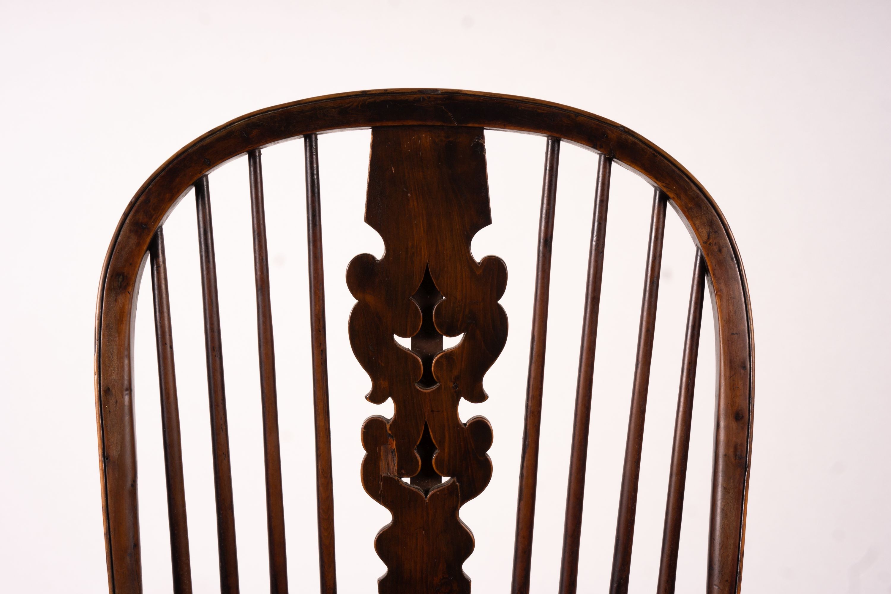 A mid 19th century yew and elm Yorkshire area Windsor armchair with saddle-seat and crinoline stretcher, width 63cm, depth 47cm, height 110cm